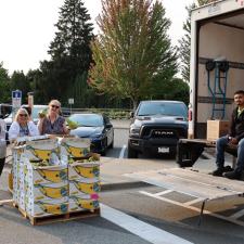 Four Volunteers waiting to hand out food items to families