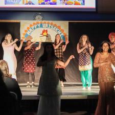 ATS Staff on stage performing a Bhangra dance