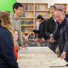 Superintendent Nosek grabbing a certificate from a table